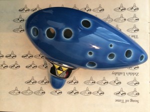I couldn't resist getting this Songbird Limited Edition Ocarina of Time Replica. The ocarina rests on a songbook included with the instrument.